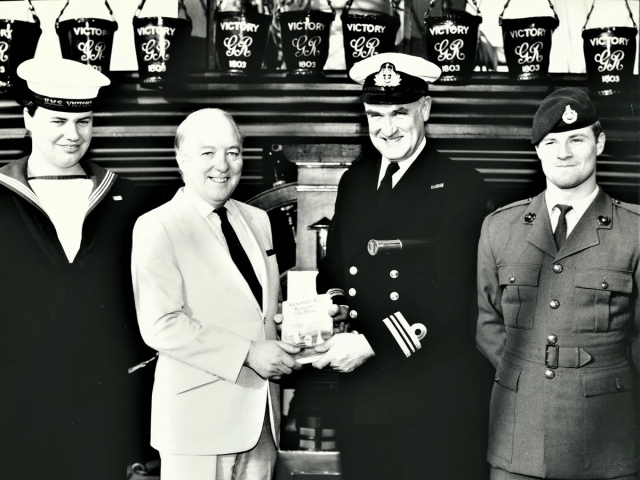 Aboard HMS Victory with her commanding officer and members of her company, at the presentation of the 'Bolitho Collection'.