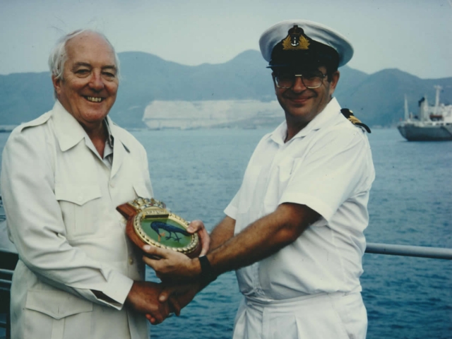 With the captain of HMS Starling in Hong Kong, receiving the ship's crest.